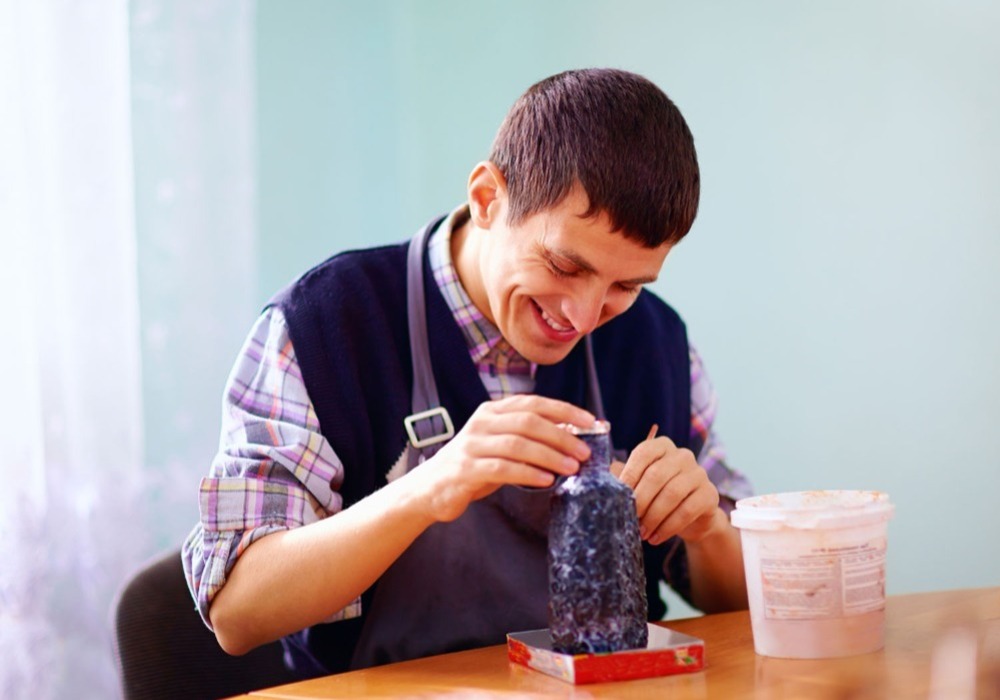 A care worker creating crafts